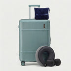 Memory foam neck pillow and travel blanket arranged beside suitcase